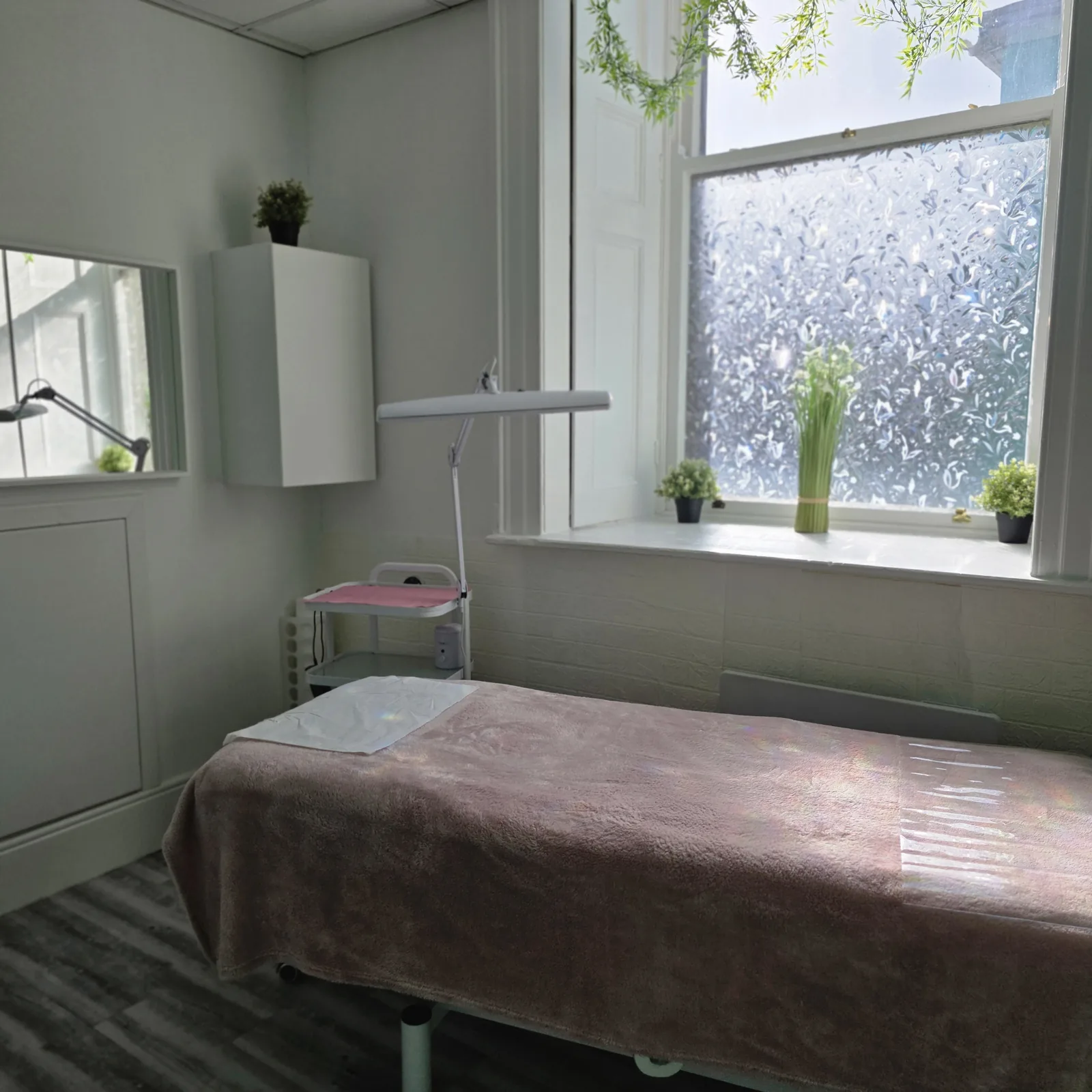 Bright treatment room with treatment bed